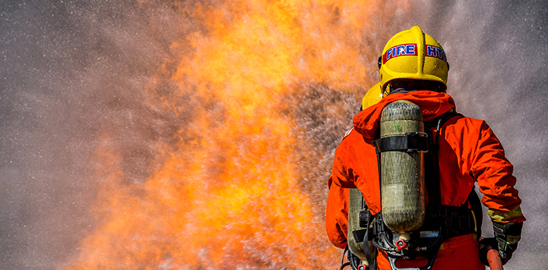 Worker standing in front of blaze of fire