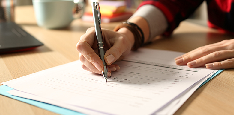 Woman filling out form at home