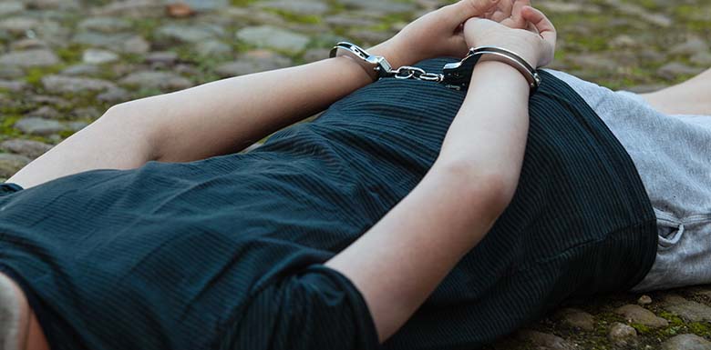 Man being arrested laying on the ground