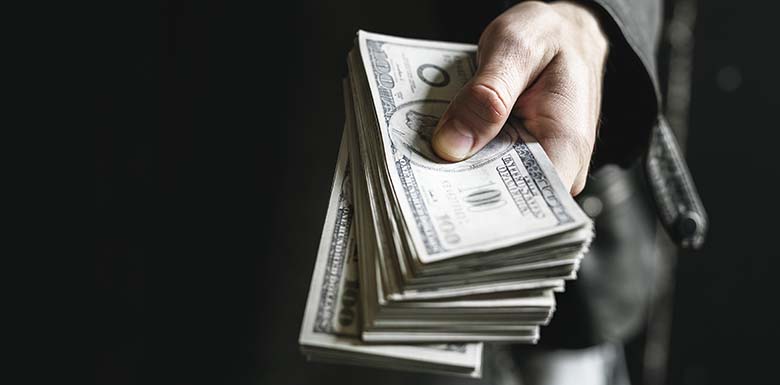 Man holding large stack of cash