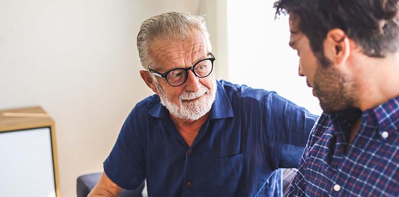 Older father talking to adult son about power of attorney