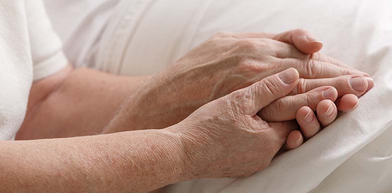 Person holder older man's hand